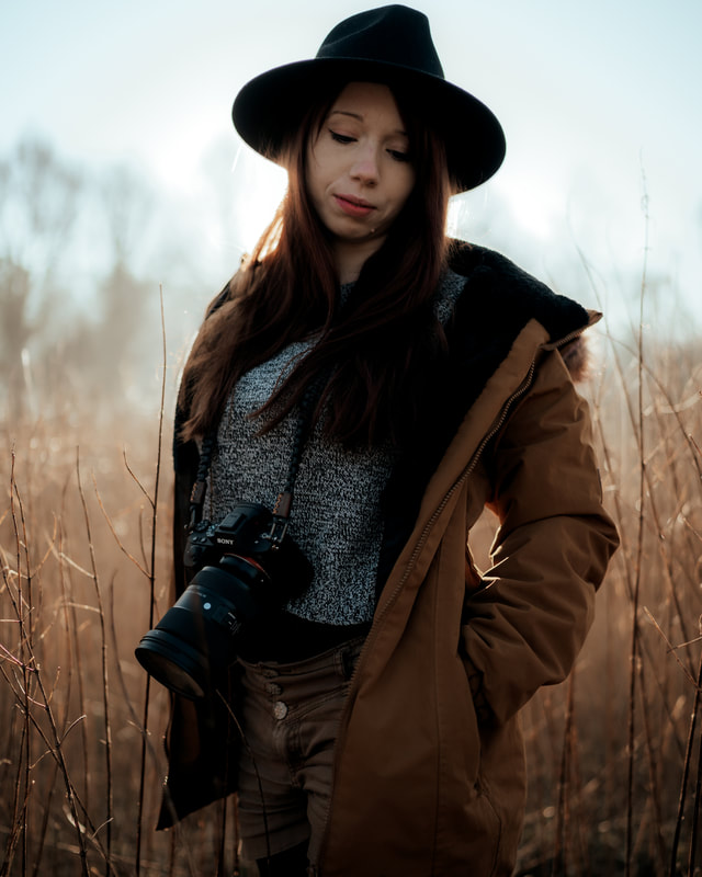 Girl in field backlit with camera